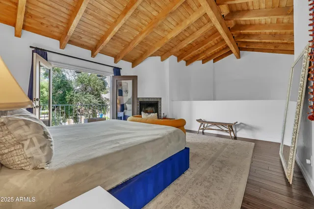 a bed sitting in a bedroom next to a window