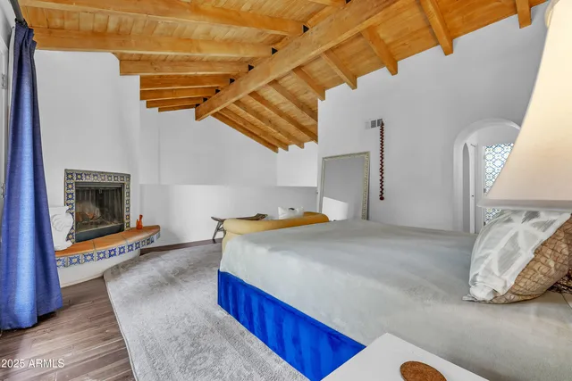 a bedroom with a bed and a fireplace