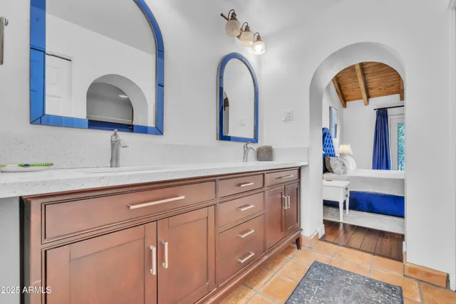 a bathroom with 2 sink and a mirror