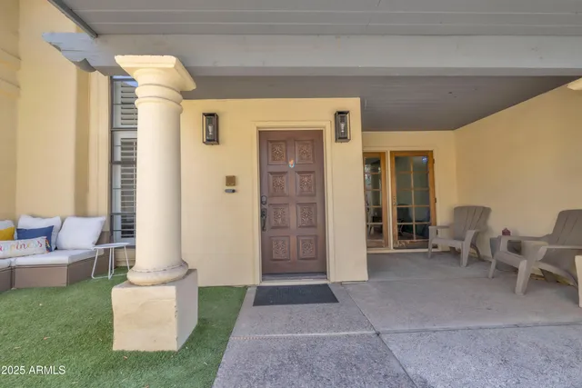 a view of a backyard with plants and outdoor seating