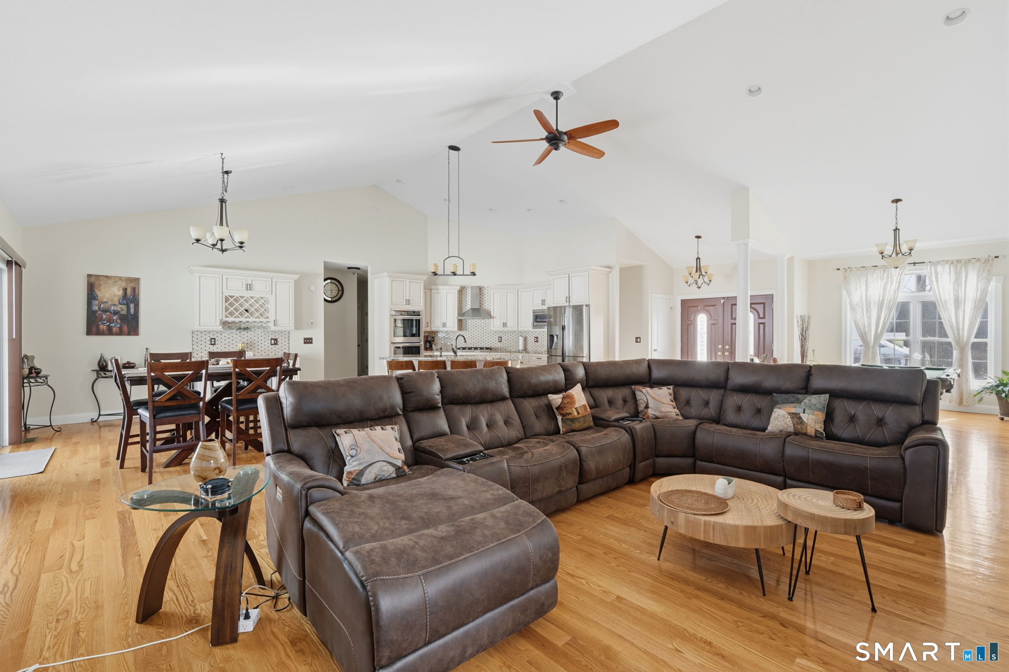 16 Crystal Brook Road Wolcott, CT 06716 - Photo 12 of 40 a living room with furniture kitchen view and a chandelier