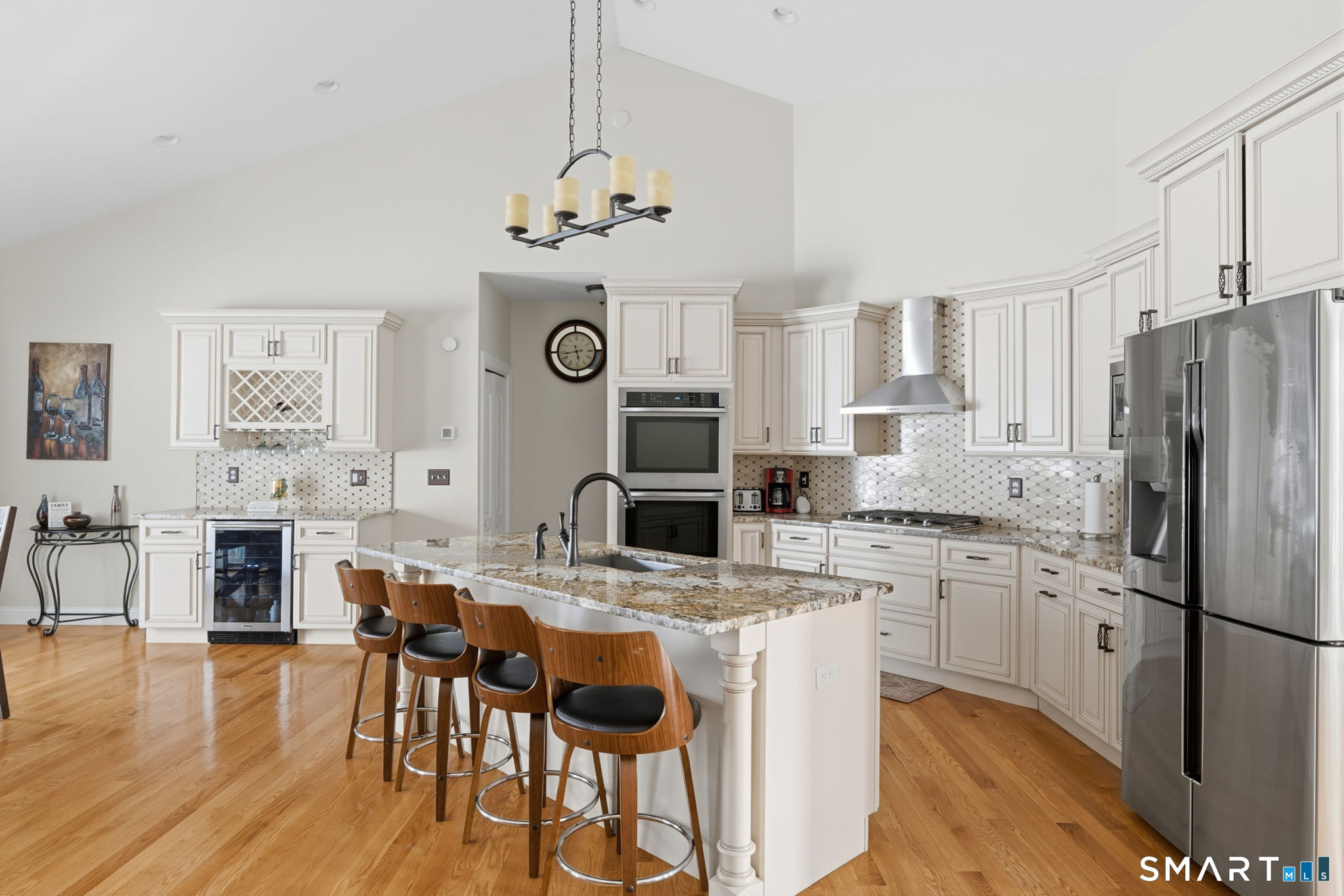 16 Crystal Brook Road Wolcott, CT 06716 - Photo 15 of 40 a kitchen with stainless steel appliances a stove a refrigerator a sink dishwasher a dining table and chairs with wooden floor