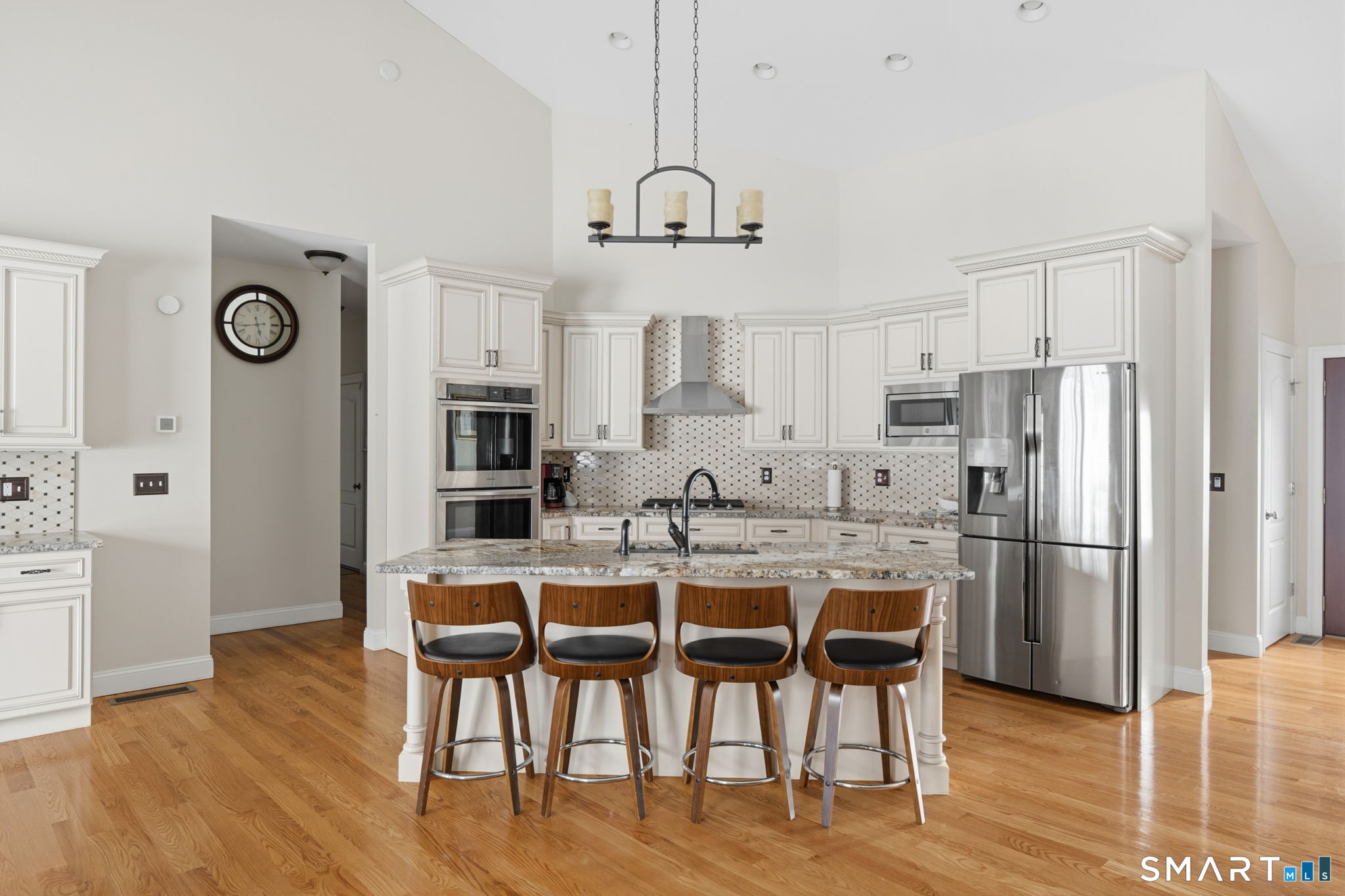 16 Crystal Brook Road Wolcott, CT 06716 - Photo 16 of 40 a kitchen with stainless steel appliances a dining table chairs refrigerator and cabinets