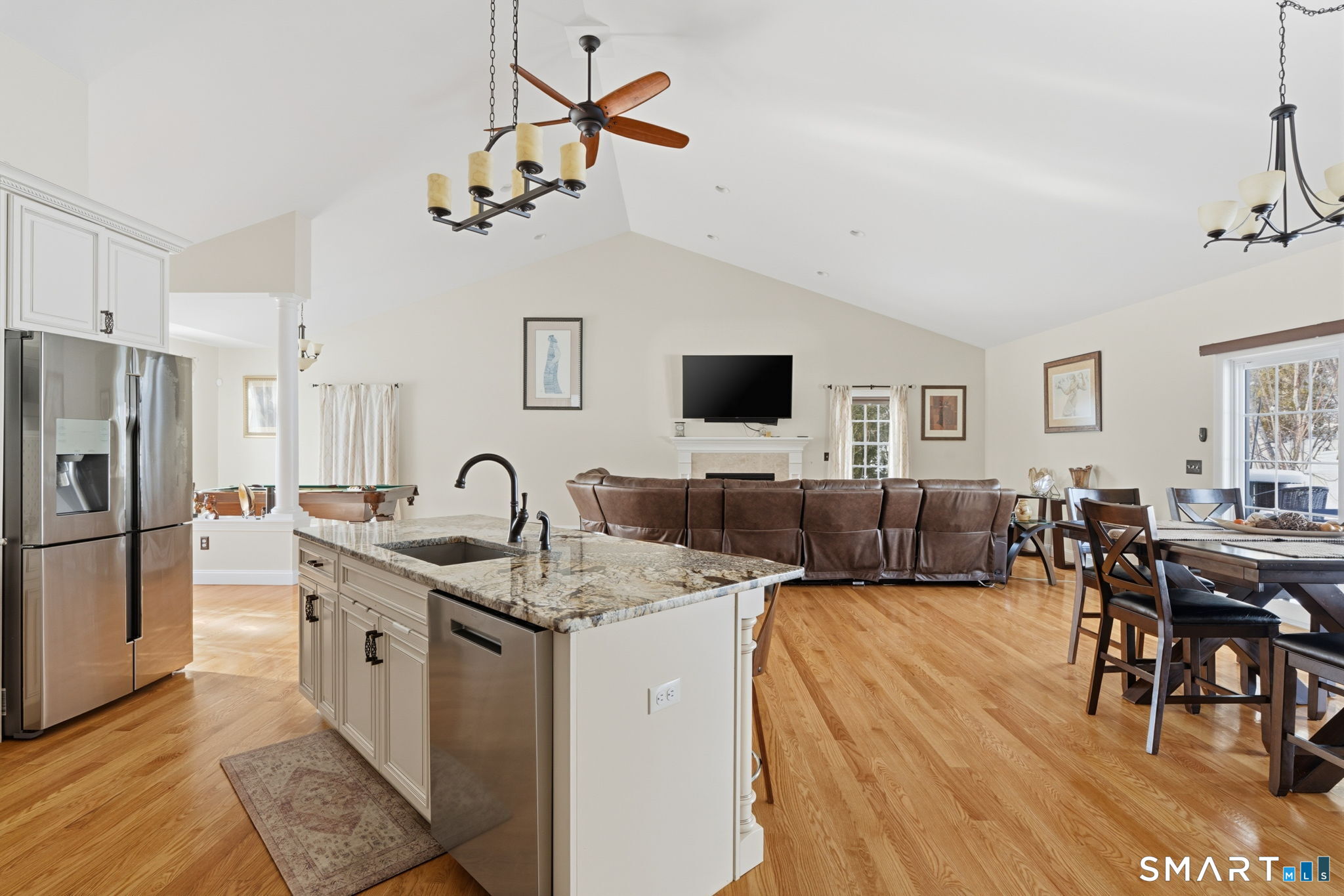 16 Crystal Brook Road Wolcott, CT 06716 - Photo 19 of 40 a living room with furniture a dining table and kitchen view