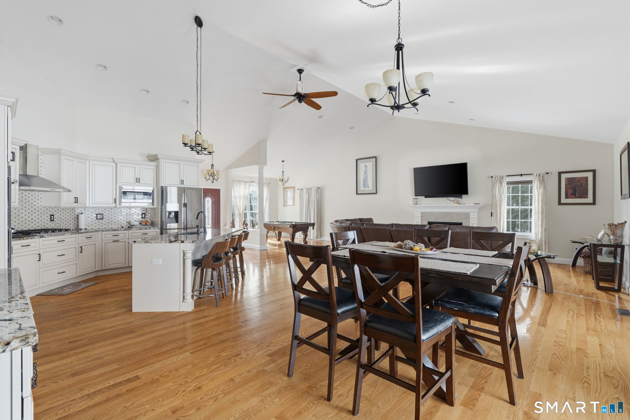 16 Crystal Brook Road Wolcott, CT 06716 - Photo 22 of 40 a view of a dining room and livingroom with furniture wooden floor a chandelier