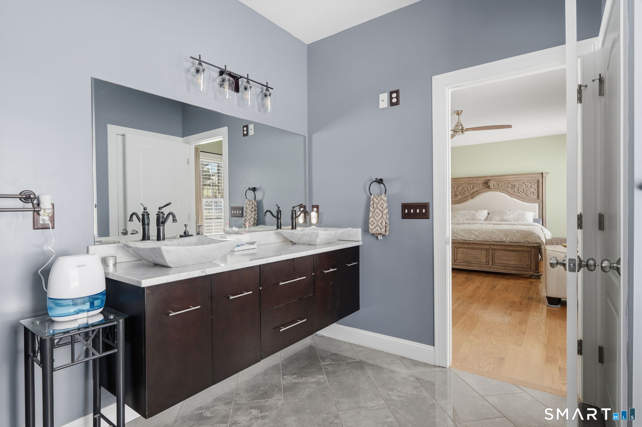16 Crystal Brook Road Wolcott, CT 06716 - Photo 36 of 40 a en suite bathroom with a double vanity sink and a mirror