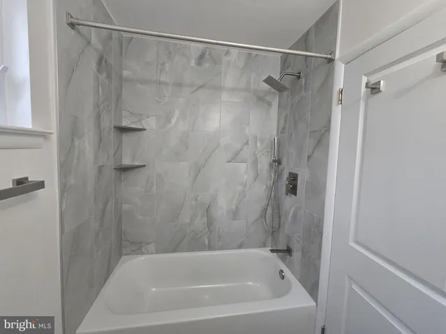 a bathroom with a shower and a bath tub