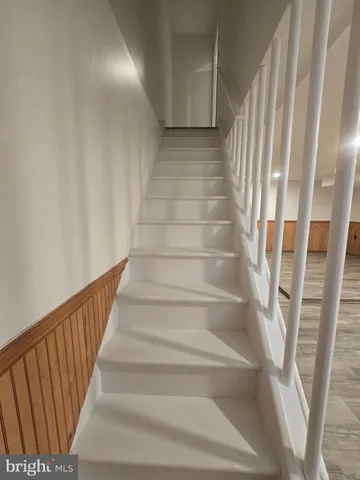 a view of staircase with white walls and a window