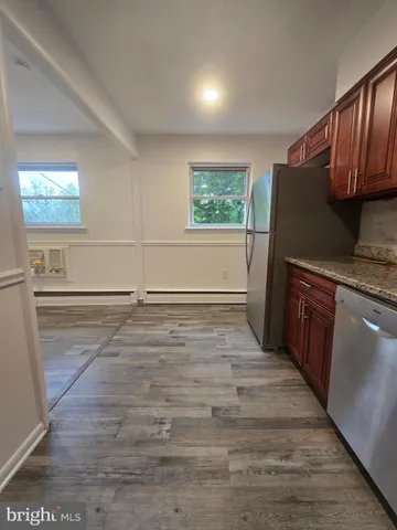 a kitchen with granite countertop a stove and a refrigerator