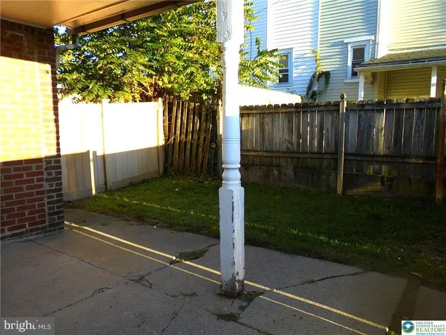 a view of backyard with wooden fence