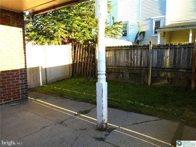 a view of backyard with wooden fence
