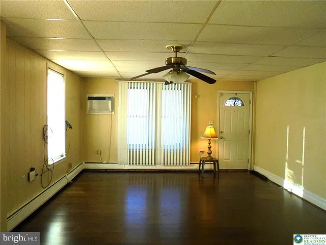 a view of empty room with wooden floor