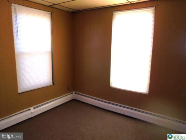 a view of an empty room and a window