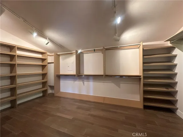 a view of walk in closet with empty racks