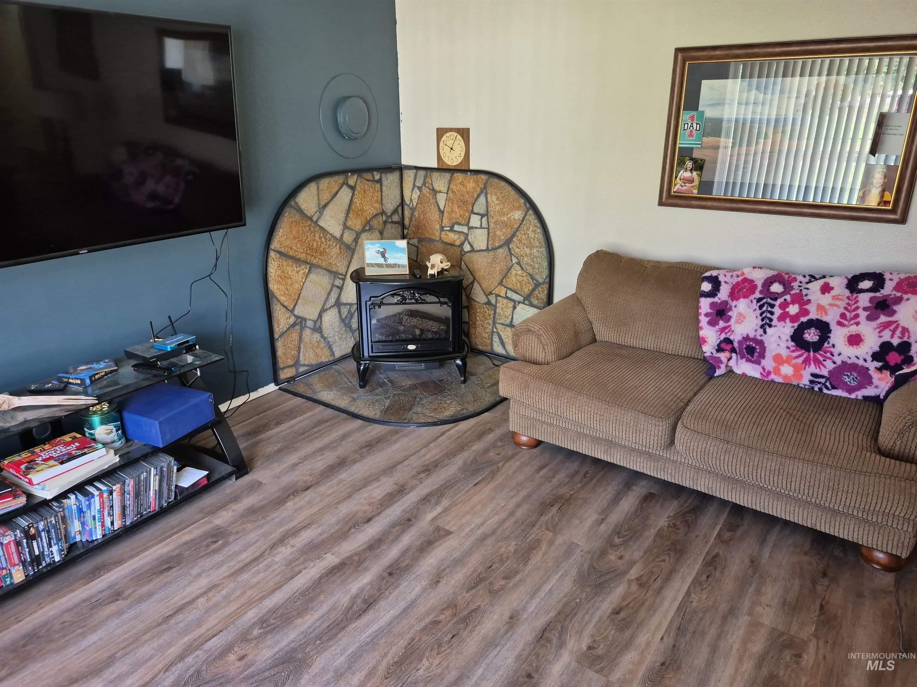 701 Wheeler Street Kendrick, ID 83537 - Photo 16 of 32 Living area featuring a wood stove and wood finished floors