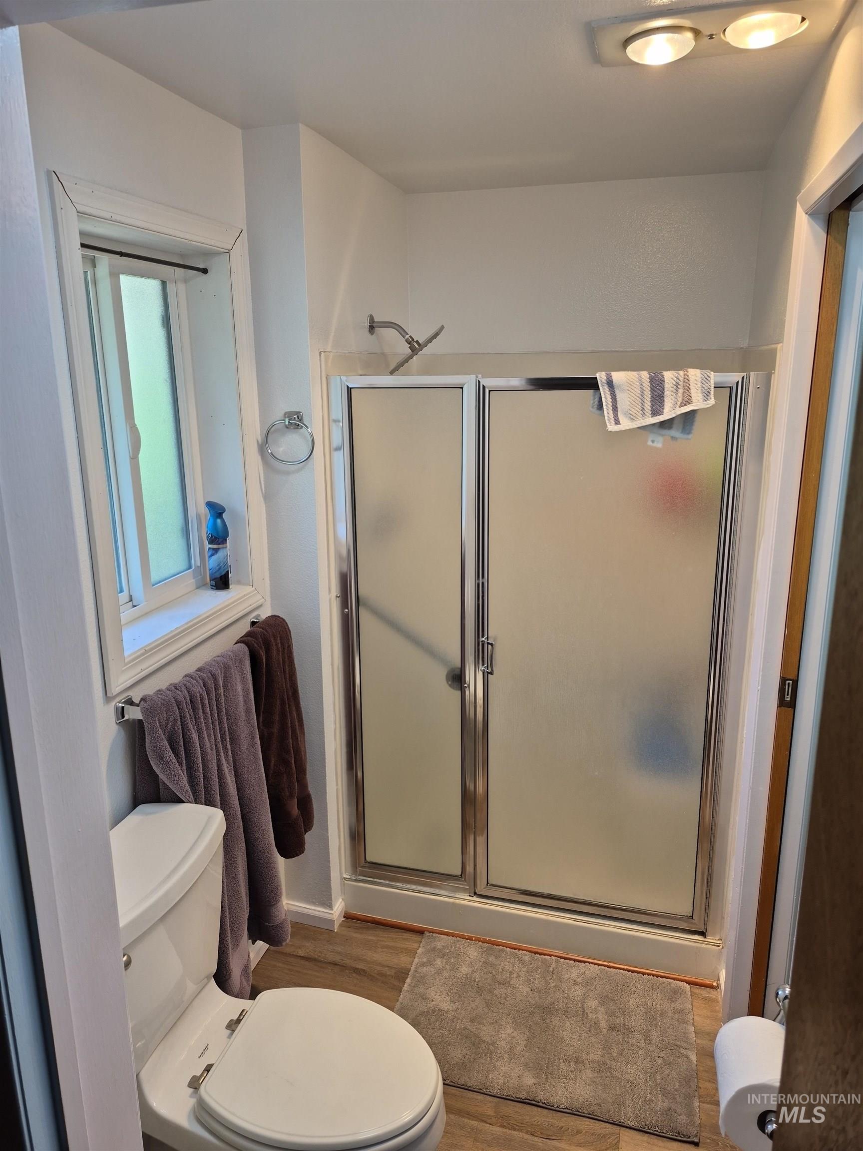 701 Wheeler Street Kendrick, ID 83537 - Photo 19 of 32 Bathroom with a stall shower and wood finished floors