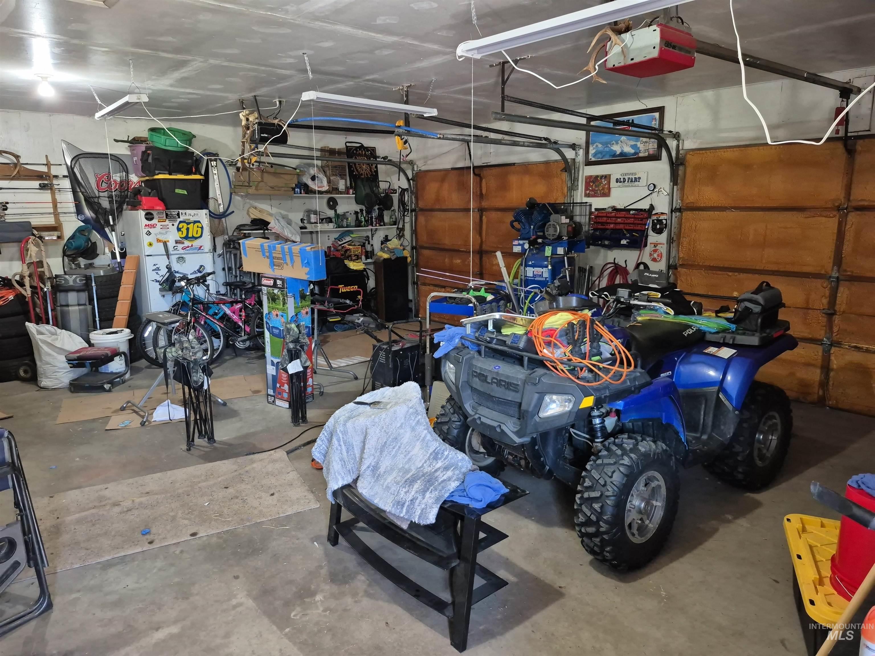701 Wheeler Street Kendrick, ID 83537 - Photo 6 of 32 Garage with a garage door opener and freestanding refrigerator