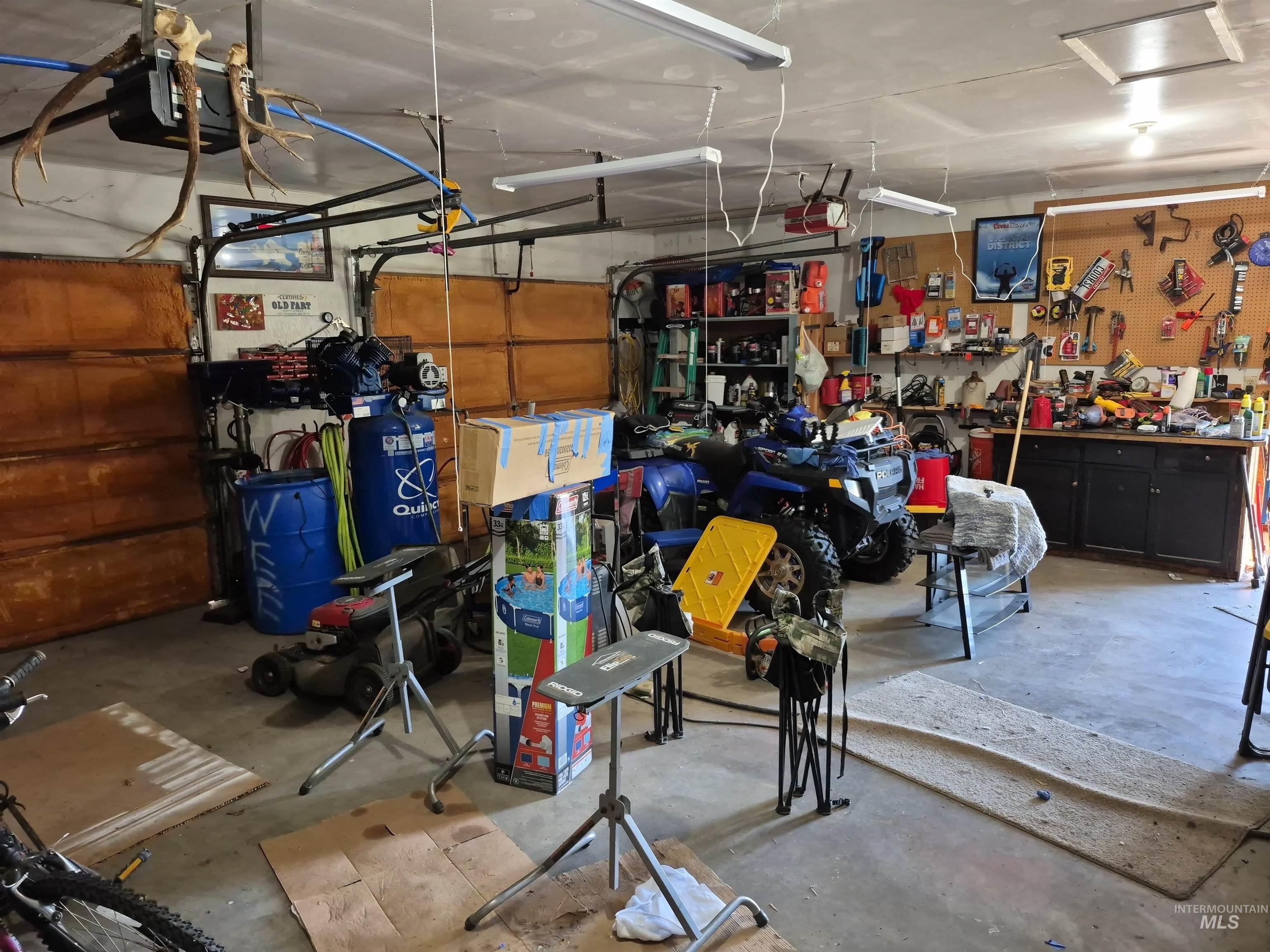 701 Wheeler Street Kendrick, ID 83537 - Photo 7 of 32 Garage featuring a workshop area and a garage door opener