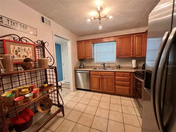a kitchen with stainless steel appliances granite countertop a stove a sink dishwasher and a refrigerator