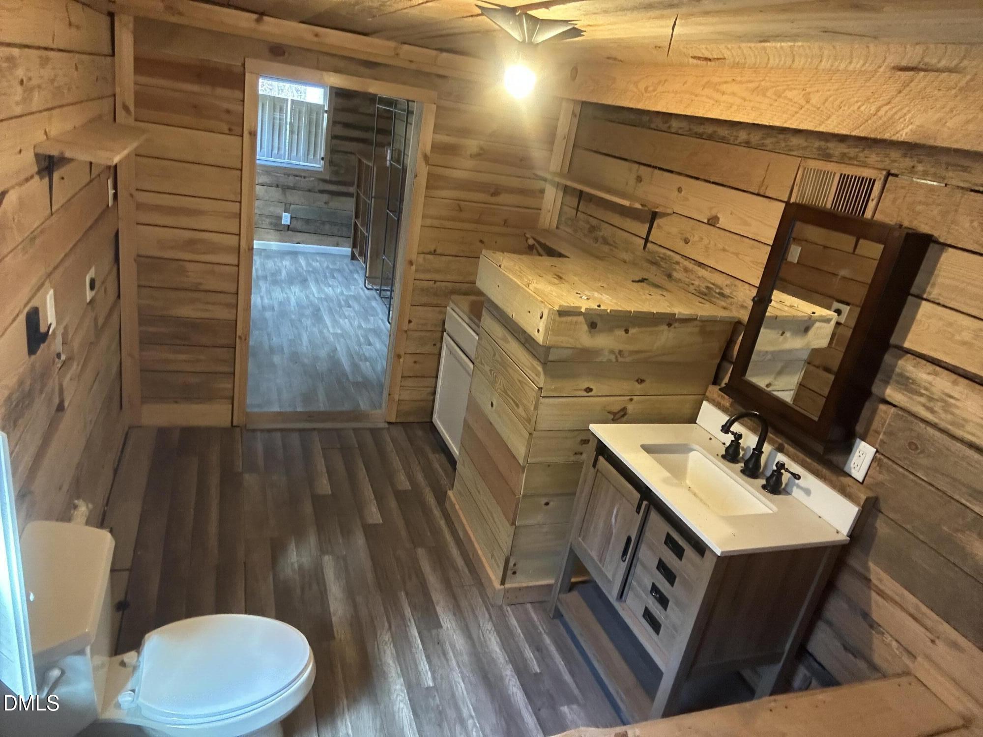 8205 Old Switchboard Road Snow Camp, NC 27349 - Photo 11 of 25 a bathroom with a sink mirror vanity and toilet