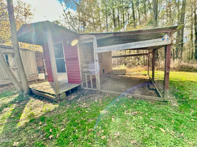 a backyard of a house with table and chairs