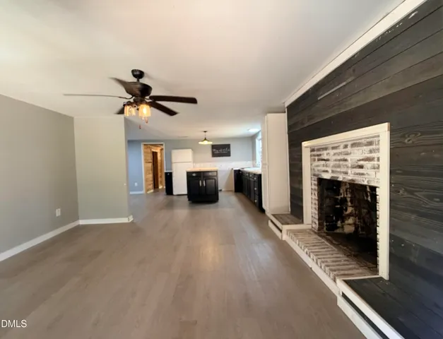 a view of living room with furniture and fireplace