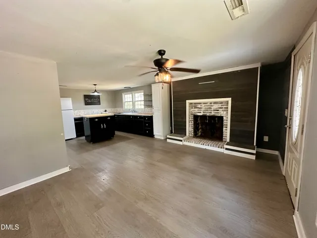 a view of a livingroom with a fireplace and window