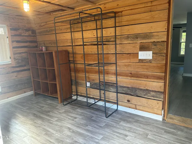 a view of a room with wooden floor and white walls