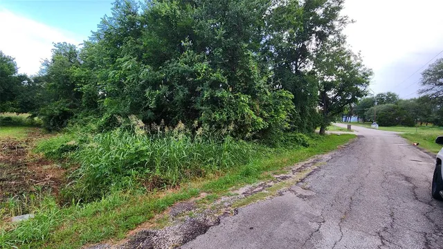a view of a road with a yard