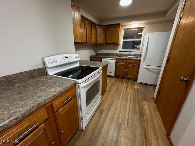 6606 Crossview Road Independence, OH 44131 - Photo 2 of 17 Kitchen with white appliances, dark countertops, brown cabinets, and dark wood-type flooring