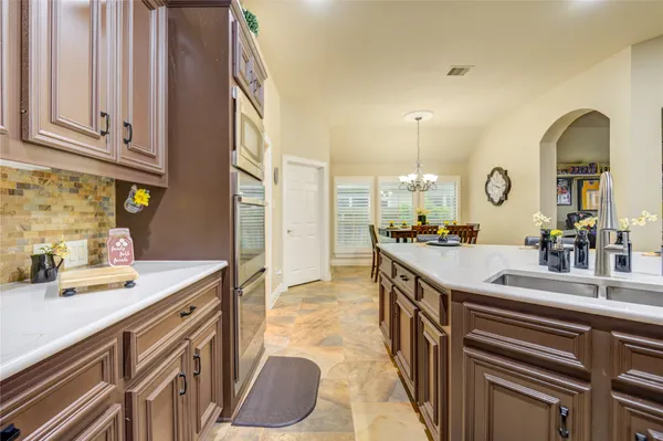 a kitchen with granite countertop stainless steel appliances white cabinets sink and dishwasher