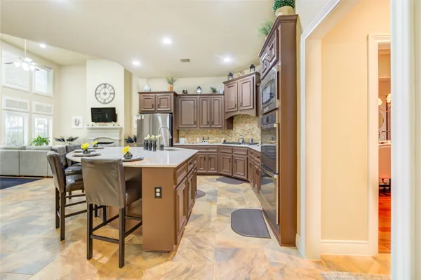 a spacious bathroom with a granite countertop sink a large mirror and a bathtub