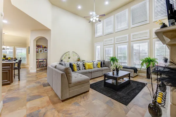 a living room with furniture a flat screen tv and a fireplace