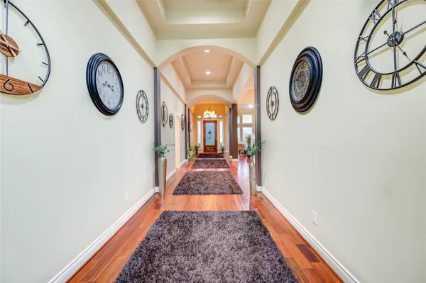 a bedroom with a bed a chandelier and a window