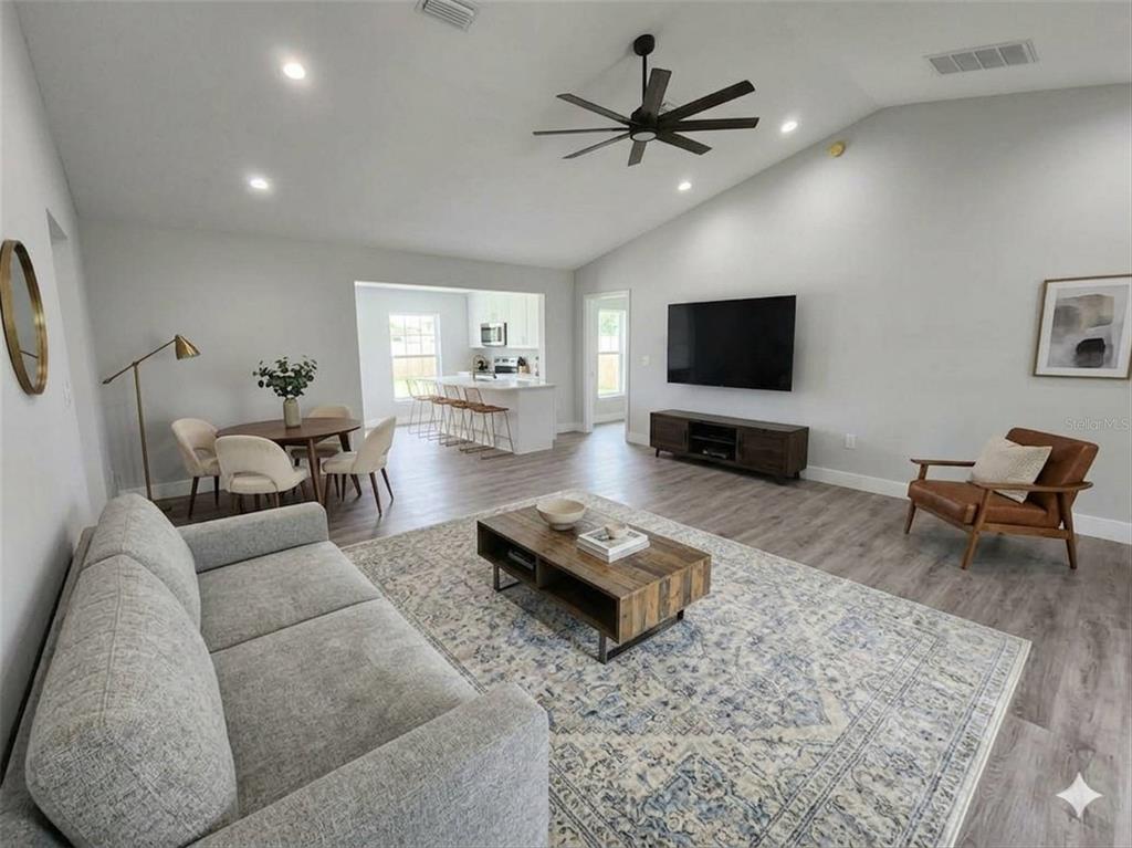 1111 Dagmar Avenue Spring Hill, FL 34606 - Photo 24 of 27 a living room with furniture and a flat screen tv