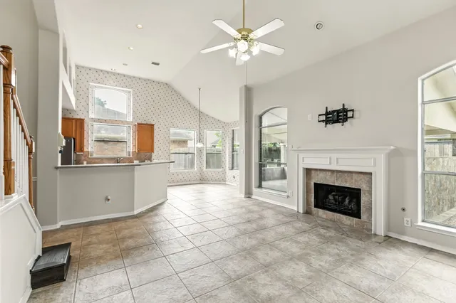 a kitchen with stainless steel appliances kitchen island granite countertop a sink and a refrigerator