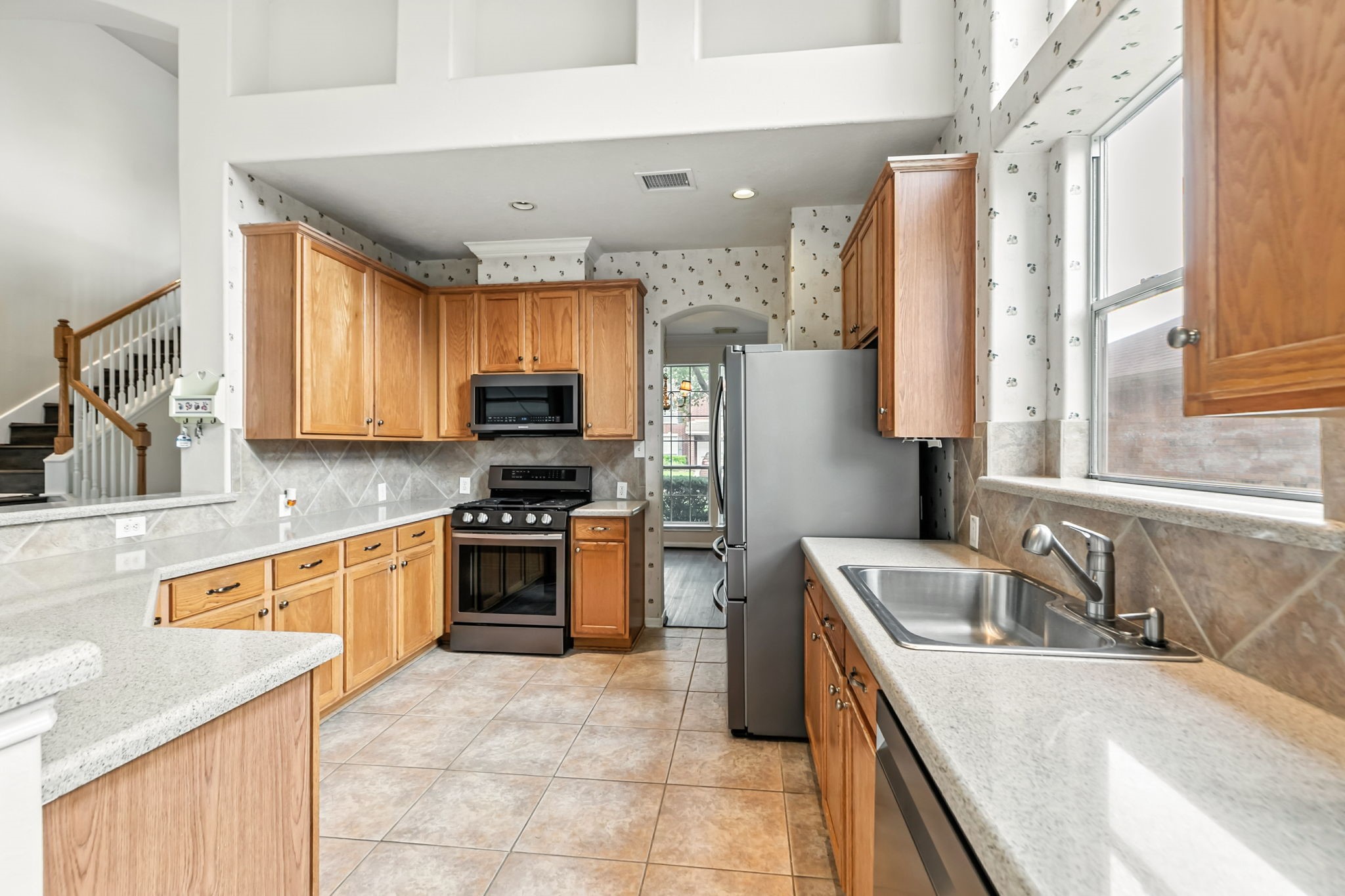 20907 Divellec Lane Spring, TX 77388 - Photo 17 of 46 a kitchen with a sink a stove top oven and refrigerator