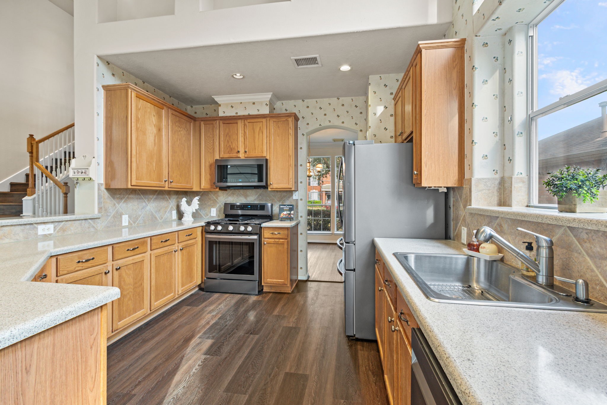20907 Divellec Lane Spring, TX 77388 - Photo 17 of 50 a kitchen with stainless steel appliances granite countertop a sink dishwasher stove and refrigerator