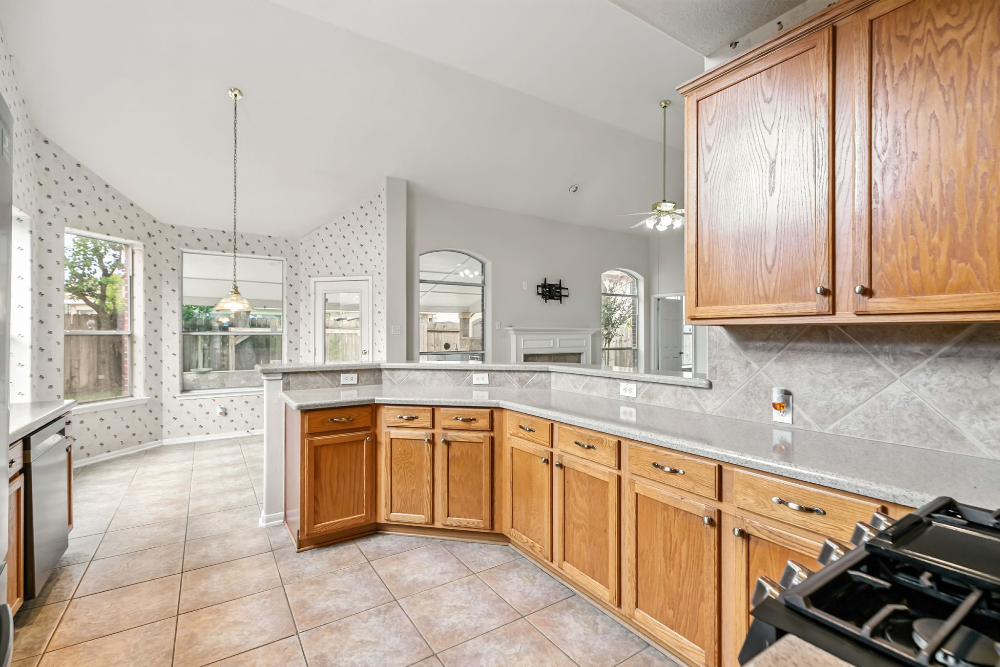 20907 Divellec Lane Spring, TX 77388 - Photo 18 of 46 a large kitchen with granite countertop a stove sink and cabinets