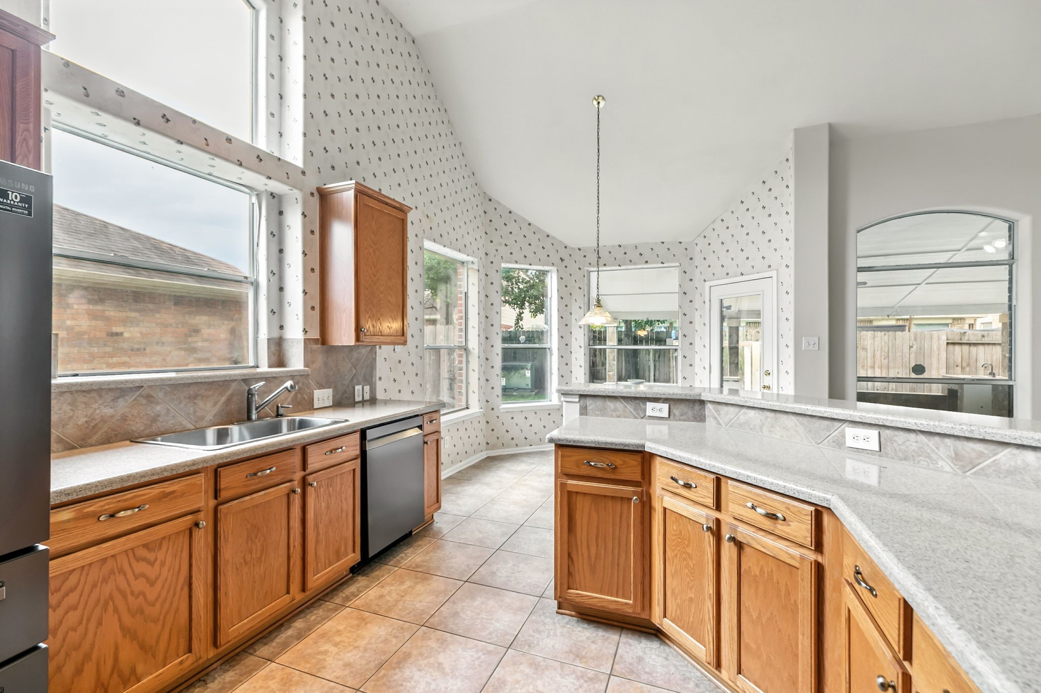 20907 Divellec Lane Spring, TX 77388 - Photo 19 of 46 a large kitchen with stainless steel appliances granite countertop a sink and a large window