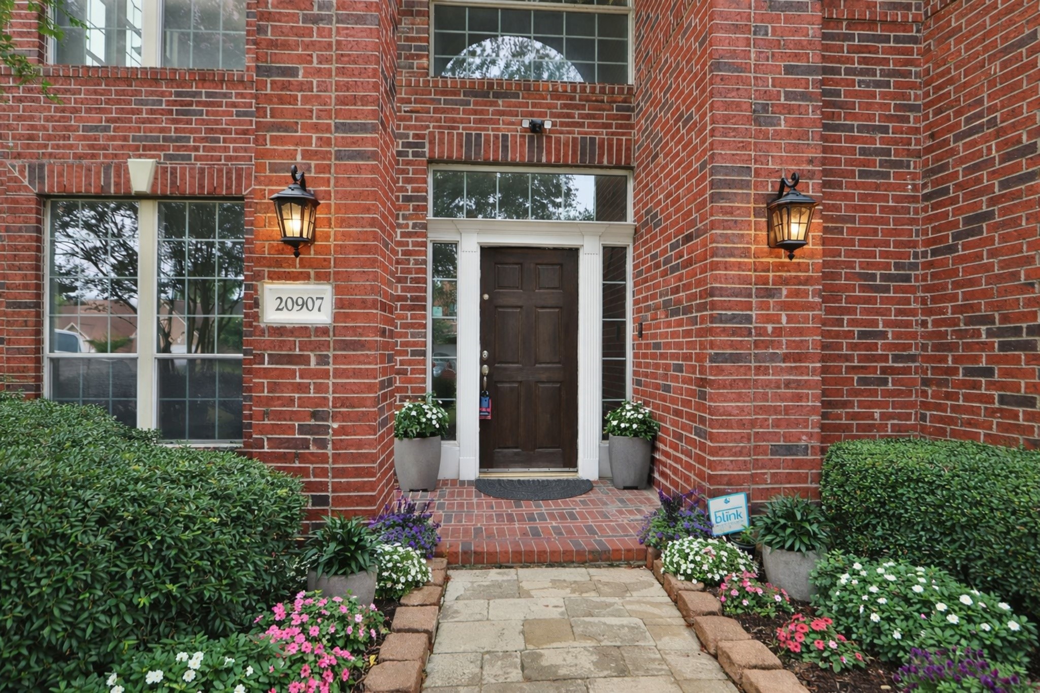 20907 Divellec Lane Spring, TX 77388 - Photo 2 of 50 a stone house with potted plants in front of door