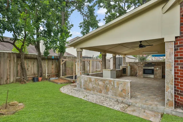 a view of a chair and table in backyard of the house