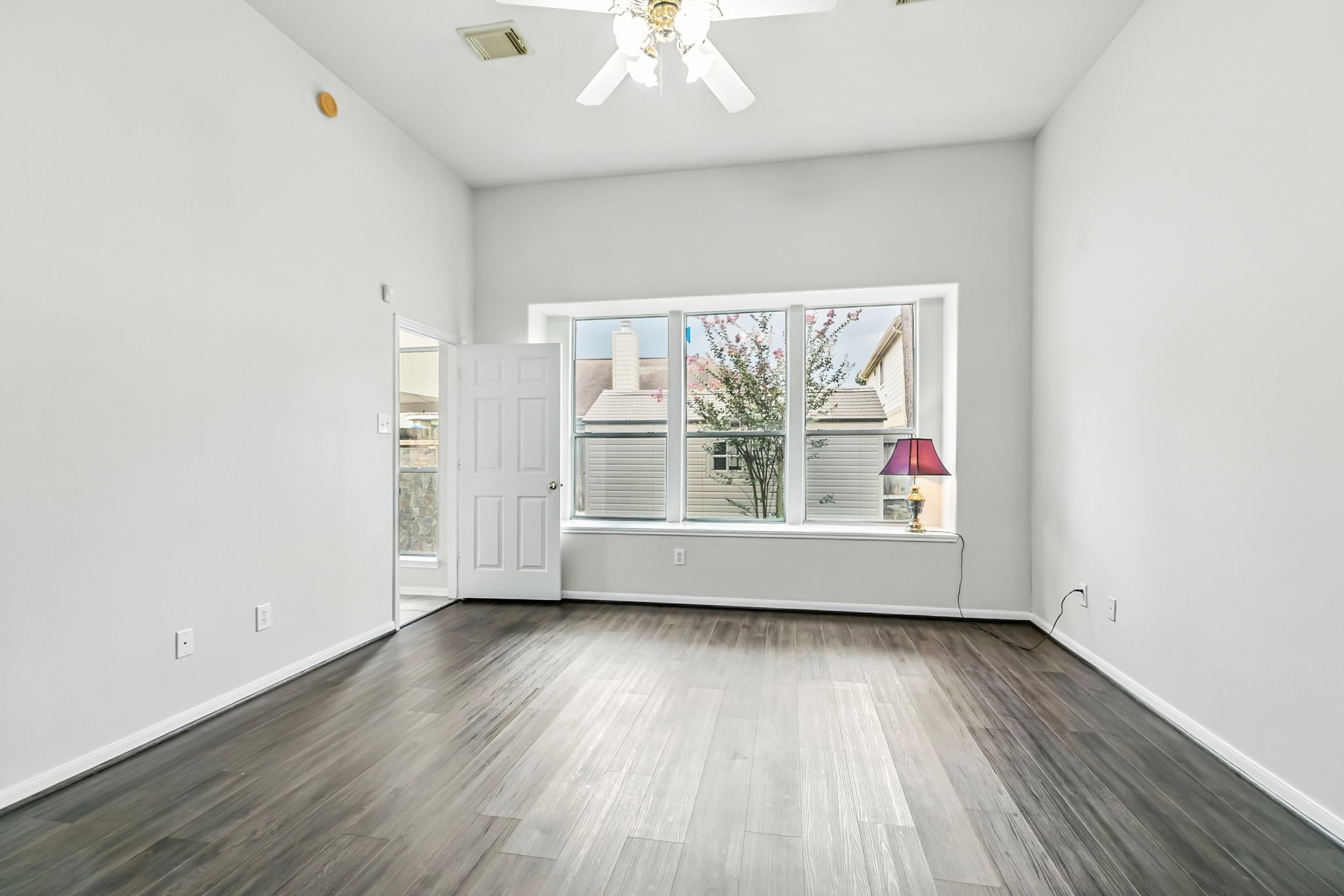 20907 Divellec Lane Spring, TX 77388 - Photo 23 of 46 an empty room with wooden floor and windows