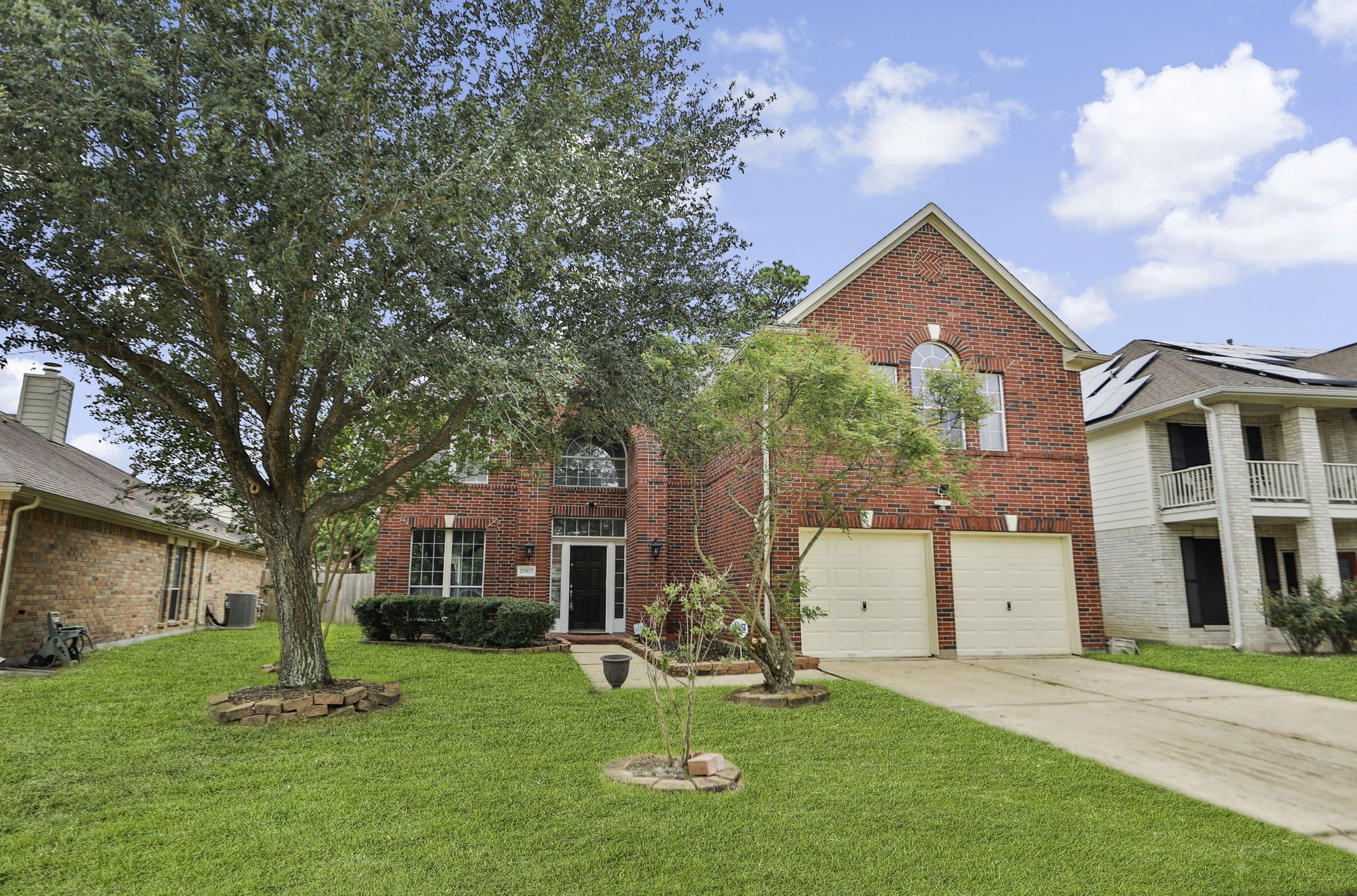20907 Divellec Lane Spring, TX 77388 - Photo 3 of 46 a front view of a house with a yard and garage