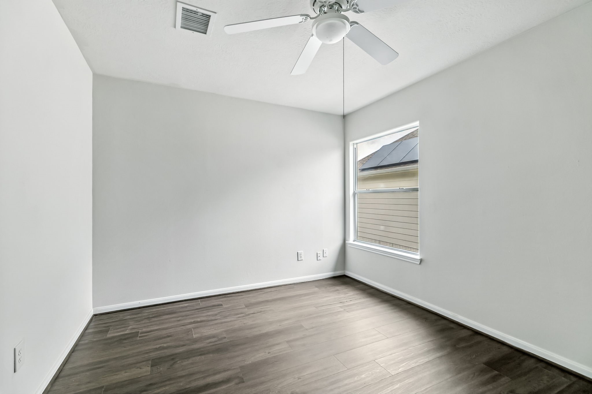 20907 Divellec Lane Spring, TX 77388 - Photo 31 of 46 an empty room with wooden floor chandelier fan and windows