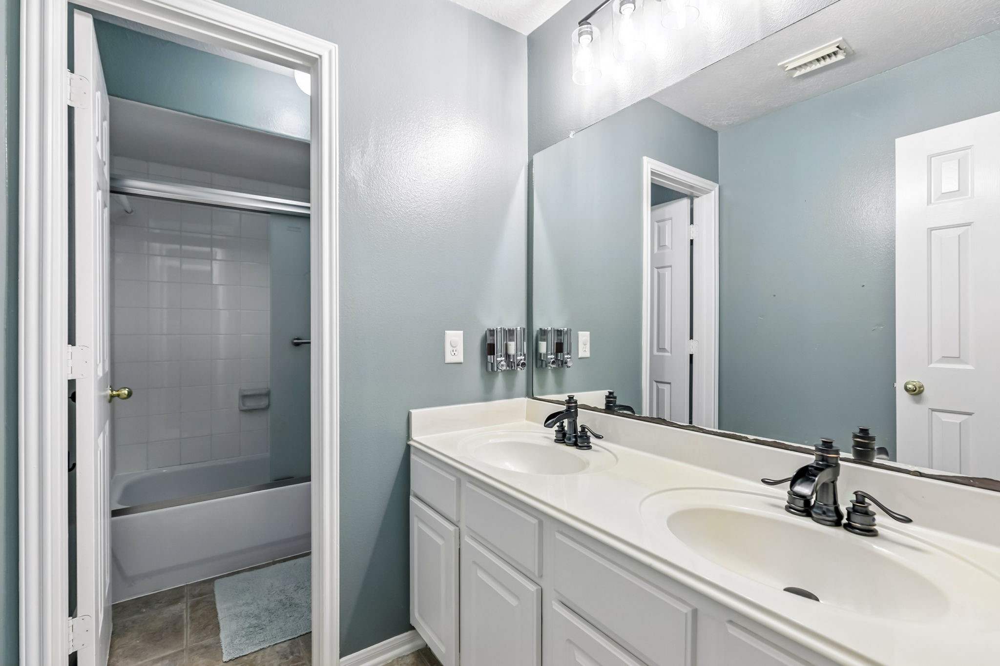 20907 Divellec Lane Spring, TX 77388 - Photo 35 of 50 A shared upstairs bathroom featuring two sinks and a separate shower for added privacy.