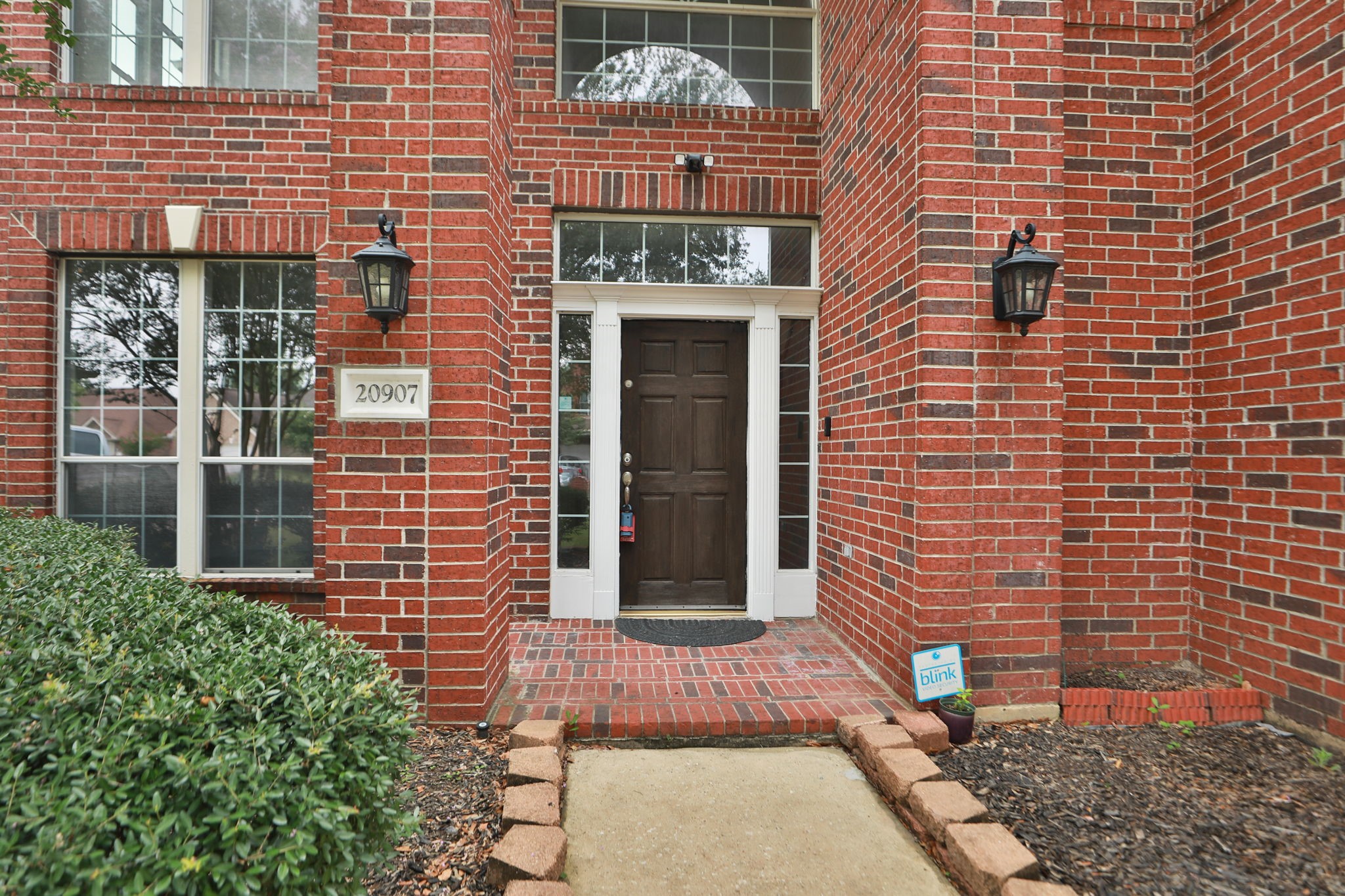 20907 Divellec Lane Spring, TX 77388 - Photo 6 of 46 a brick building with a door and a window