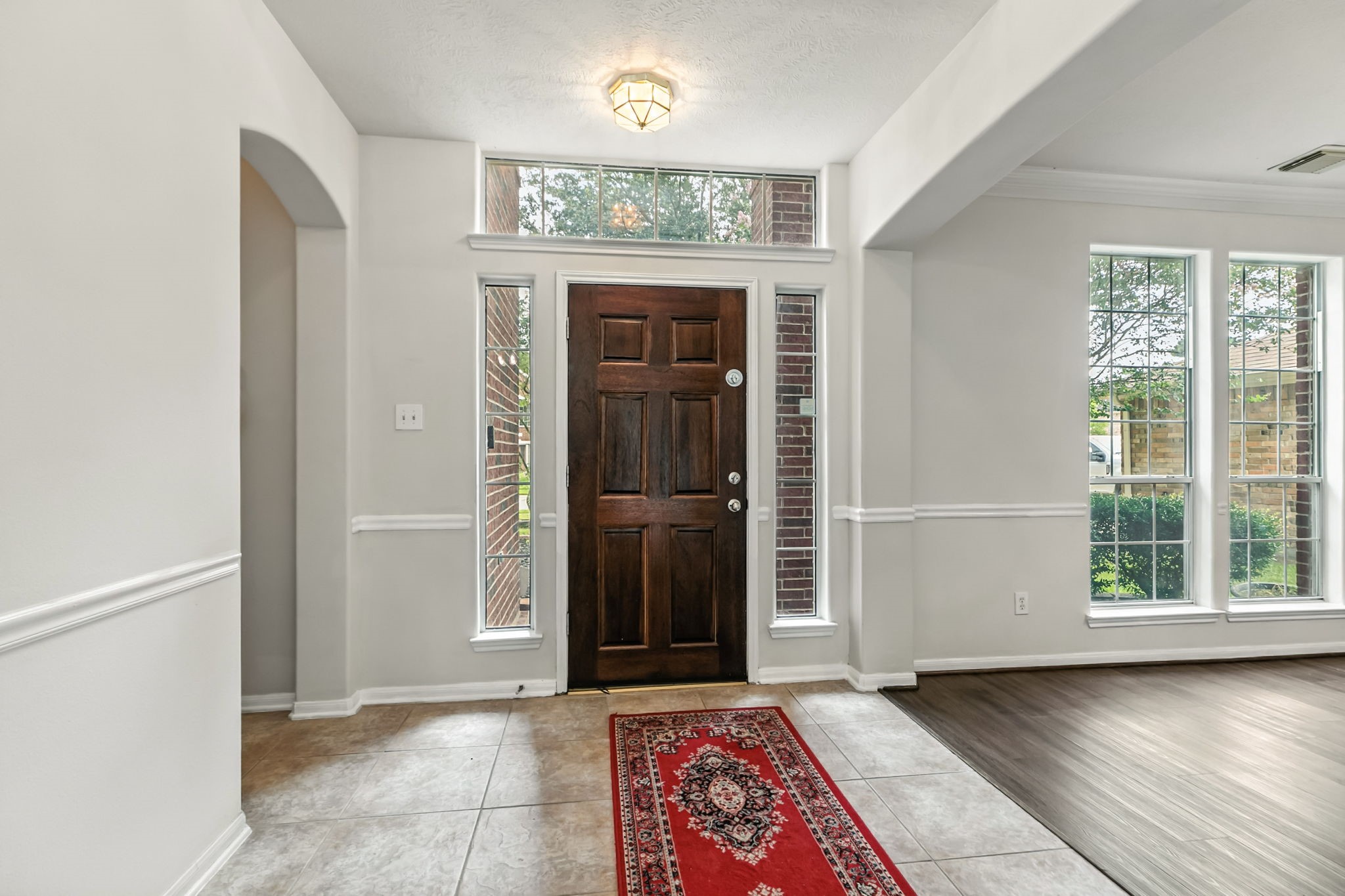 20907 Divellec Lane Spring, TX 77388 - Photo 8 of 46 an entryway at an empty room with wooden floor and a window