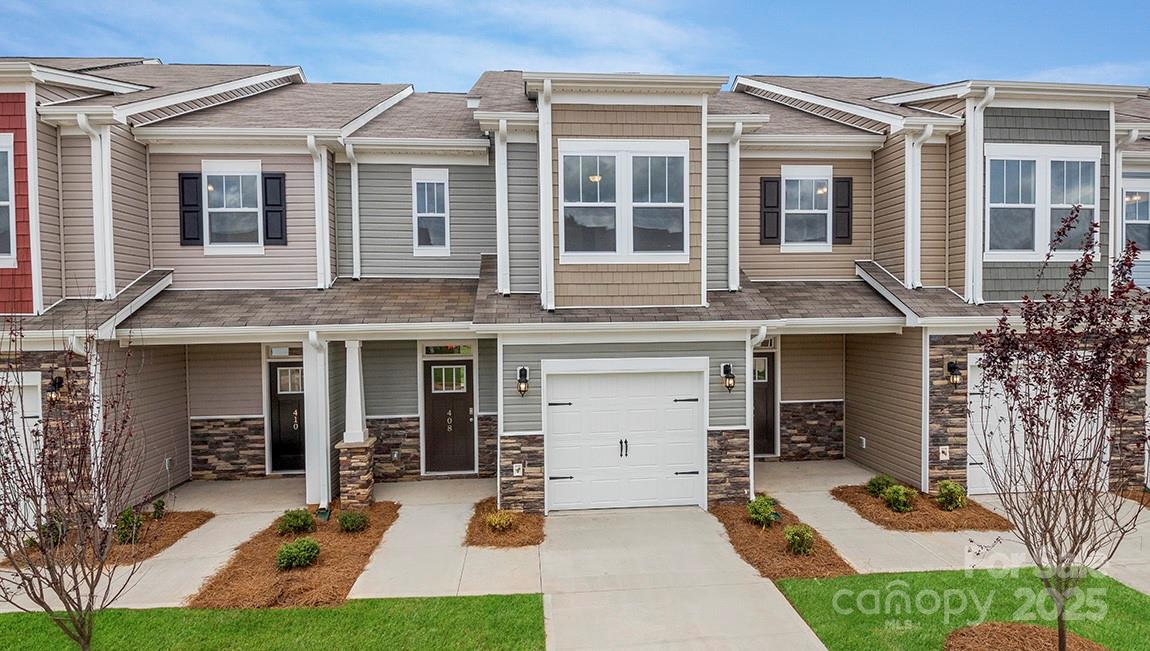 367 Lagoon Road Fletcher, NC 28732 - Photo 1 of 30 a view of a white house with large windows and couches