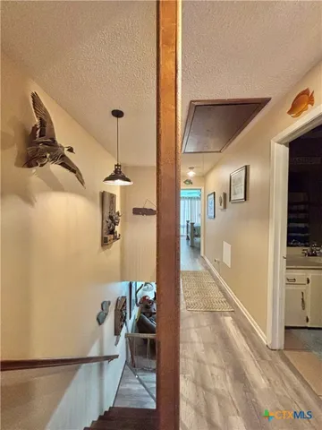 a hallway with a view of living room